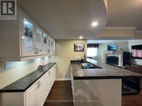 Georgina (Keswick North) apartment for rent - A kitchen with white cabinets and a black countertop.