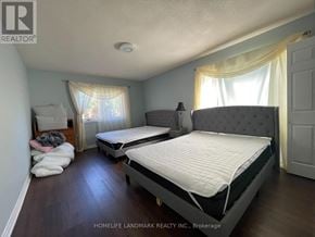 Georgina (Keswick North) apartment for rent - A bedroom with two beds and a window with curtains.