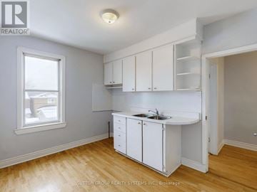 Toronto (Corso Italia-Davenport) apartment for rent - A kitchen with white cabinets and a window.