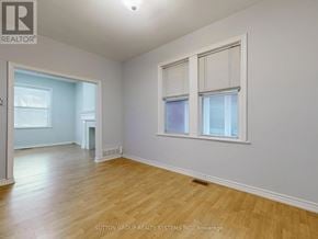 Toronto (Corso Italia-Davenport) apartment for rent - A room with wooden flooring and two windows.