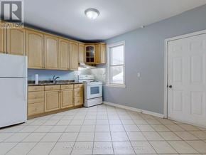 Toronto (Corso Italia-Davenport) apartment for rent - A kitchen with white appliances and wooden cabinets.
