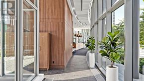 Toronto (Bayview Village) condo for rent - A hallway with a wooden door and a plant in a white pot.