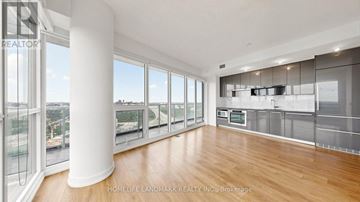 Toronto (Bayview Village) condo for rent - A spacious kitchen with wooden floors and stainless steel appliances.