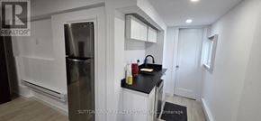 Oakville (Wo West) apartment for rent - A kitchen with a refrigerator, sink, and countertop.