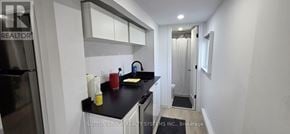 Oakville (Wo West) apartment for rent - A kitchen with a black counter top and white cabinets.
