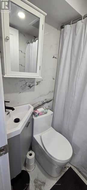 Oakville (Wo West) apartment for rent - A white toilet in a small bathroom with a white shower curtain.