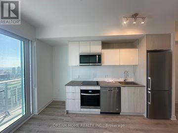 Toronto (Church-Yonge Corridor) condo for rent - A modern kitchen with stainless steel appliances and a view of the city.