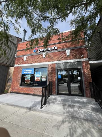 Picton apartment for rent - A Donut's shop with a blue signboard and a black gate.