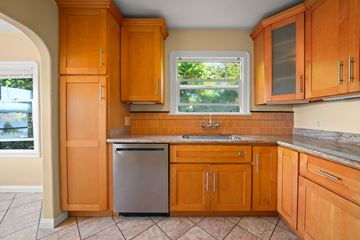 Crockett apartment for rent - A kitchen with wooden cabinets and a stainless steel dishwasher.