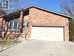 Hamilton apartment for rent - A red brick house with a white garage door.