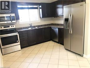 Hamilton apartment for rent - A kitchen with a refrigerator, oven, and sink.
