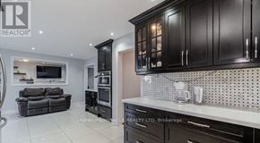 Brampton (Northwood Park) apartment for rent - A modern kitchen with black cabinets and a white countertop.