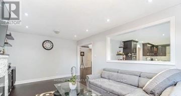 Brampton (Northwood Park) apartment for rent - A living room with a grey sofa and a glass coffee table.