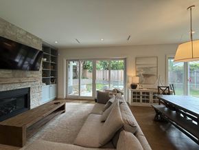 Surrey apartment for rent - A modern living room with a fireplace and a large couch.