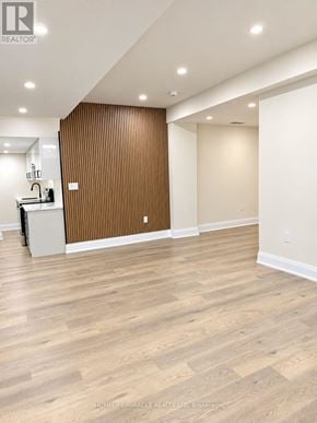 Vaughan (Kleinburg) apartment for rent - A room with wooden flooring and a striped wallpapered wall.