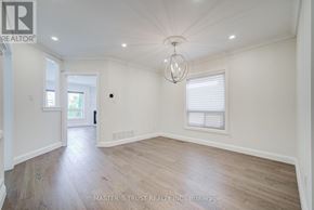 Richmond Hill (Westbrook) apartment for rent - A spacious room with wooden flooring and a chandelier hanging from the ceiling.