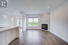 Richmond Hill (Westbrook) apartment for rent - A spacious living room with a fireplace and a large window.