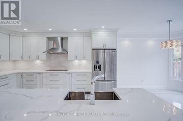 Richmond Hill (Westbrook) apartment for rent - A modern kitchen with white cabinets and marble countertops.