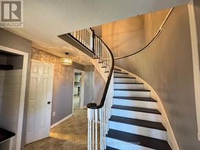 Barrie (Northwest) apartment for rent - A staircase with a black and white striped runner.