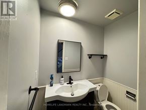 Barrie (Northwest) apartment for rent - A bathroom with a sink, mirror, and toilet.