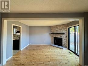 Barrie (Northwest) apartment for rent - A room with a fireplace and wooden flooring.