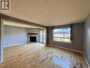 Barrie (Northwest) apartment for rent - A room with a fireplace and sliding glass doors.