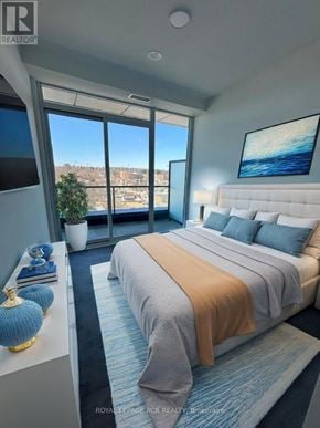 Barrie (City Centre) condo for rent - A bedroom with a large bed and a view of the city.