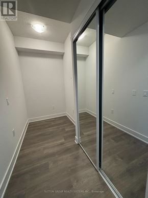 Mississauga (City Centre) condo for rent - A room with wood flooring and white walls.