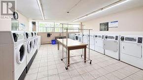 St. Catharines (Glendale/Glenridge) condo for rent - A laundry room with a table and washing machines.