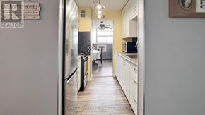 St. Catharines (Glendale/Glenridge) condo for rent - A kitchen with a fridge and a sign that says "Welcome Home".