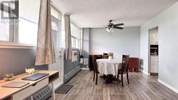 St. Catharines (Glendale/Glenridge) condo for rent - A dining room with a table set for two and a kitchen area in the background.