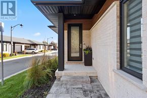 Thorold (Confederation Heights) townhouse for rent - A house with a black door and a small porch.