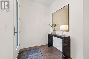 Thorold (Confederation Heights) townhouse for rent - A room with a marble fireplace and a large mirror above it.