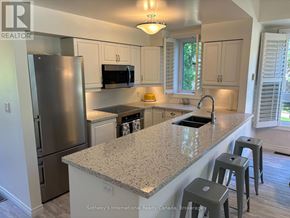 Collingwood townhouse for rent - A kitchen with granite countertops and stainless steel appliances.