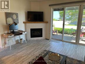 Collingwood townhouse for rent - A living room with a fireplace and sliding glass doors.