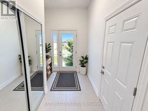 Ottawa townhouse for rent - A hallway with a door on the right and a mirror on the left.