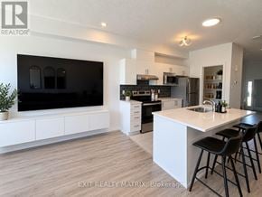 Ottawa townhouse for rent - A modern kitchen with a large island and bar stools.