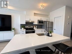 Ottawa townhouse for rent - A modern kitchen with a large island in the middle.