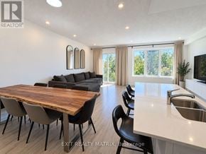 Ottawa townhouse for rent - A modern dining room with a wooden table and chairs.