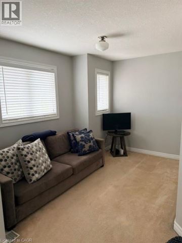 Burlington apartment for rent - A living room with a brown couch and a television.