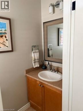 Burlington apartment for rent - A bathroom with a sink, mirror, and a picture on the wall.