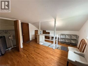 Kitchener apartment for rent - A living room with a white couch and a wooden floor.