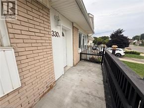 Kitchener apartment for rent - A house numbered 330 is shown with a white door and a black railing.