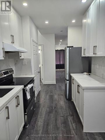 Toronto (Woburn) apartment for rent - A kitchen with white cabinets and black appliances.