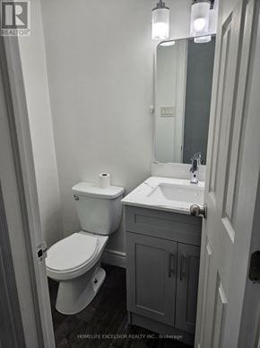 Toronto (Woburn) apartment for rent - A white toilet and sink in a small bathroom.