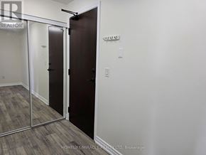Mississauga (City Centre) condo for rent - A room with a brown door and a white wall.