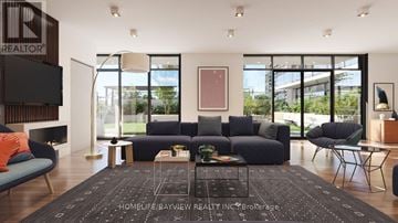 Toronto (Glenfield-Jane Heights) condo for rent - A modern living room with a large sectional sofa and a flat screen TV mounted on the wall.