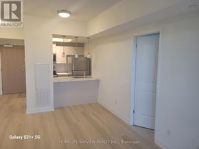 Toronto (Glenfield-Jane Heights) condo for rent - A realtor's office with a kitchen area in the background.