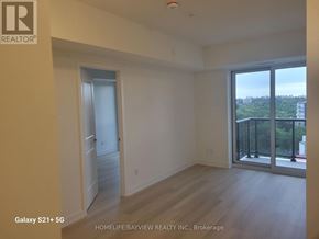 Toronto (Glenfield-Jane Heights) condo for rent - A room with a door and a window with a view of the city.
