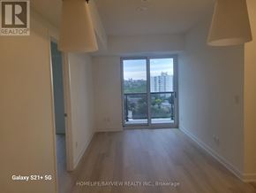 Toronto (Glenfield-Jane Heights) condo for rent - A room with a view of the city through a sliding glass door.